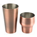Two copper cups with a white background.
