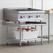 A Steelton stainless steel equipment stand with a galvanized undershelf on a counter in a professional kitchen.