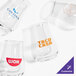 A set of four customizable 4 oz. whiskey tasting tulip glasses, each with different printed logos.