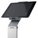 A silver metal tablet stand holding a tablet.