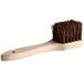 A Thunder Group wok brush with a wooden handle and brown bristles.
