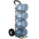 A Magliner hand truck with four water bottles on it.