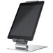 A silver metal tablet stand holding a tablet on a stand.