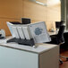 A desk with a Durable SHERPA letter sized desktop reference system on it.