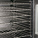 The open door of a Garland convection oven with metal racks of food inside.