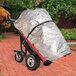 A Magliner motorized hand truck with a tarp on it.