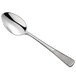 A stainless steel demitasse spoon with a textured handle.
