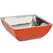 An orange Bon Chef square bowl with a silver rim.