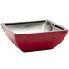 A red Bon Chef square bowl with a stainless steel rim on a counter in a salad bar.
