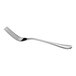 A shiny, stainless steel dinner fork with a slightly curved handle is shown against a white background.