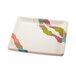 A white square plate with colorful designs.