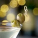 A martini with Belosa Dill Pickle Stuffed Queen Olives on a table.