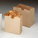 Two American Metalcraft mini paper snack bags filled with food.