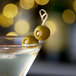 A martini with Belosa Almond and Jalapeno Stuffed Queen Olives on top.