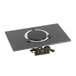 A black square Corian countertop adapter with a black and silver circular induction heating element inside.