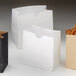Several American Metalcraft white mini snack bags with fries in them.