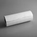 A roll of white Choice Premium Butcher Paper on a gray surface.