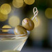 A Belosa martini with almond stuffed olives on a toothpick.