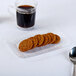 A clear Fineline Flairware plastic snack tray with a stack of cookies on it.
