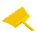 A Carlisle yellow broom with long yellow bristles and a yellow handle.