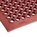 A red rubber Lavex anti-fatigue floor mat with holes.