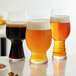 A Spiegelau Beer Classics Craft Brews tasting set with glasses of beer on a table.
