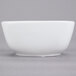 A CAC Citysquare bright white porcelain bowl on a white surface.