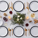 A table set with white American Metalcraft Jane Collection melamine plates and silverware.