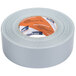 A close-up of a roll of Shurtape silver duct tape with orange and white writing on the label.