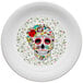 A white Fiesta china plate with a skull and vine design in the center.
