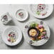 A group of Fiesta china plates with a skull and flower design on one plate.