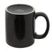 A black mug with a white rim and C-shaped handle.