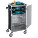 A Lakeside stainless steel meal delivery cart with trays of dishes on shelves.