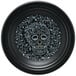 A black Fiesta luncheon plate with a skull, flowers, and leaves design.