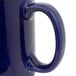A close-up of a Tuxton cobalt blue china C-handle mug.