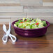 A Mulberry Fiesta china bowl filled with salad next to a pair of scissors.