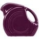 A close-up of a Fiesta Mulberry mini disc creamer pitcher with a purple handle.
