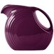 A purple pitcher with a handle.