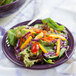A purple Fiesta® China salad plate with salad and a fork.