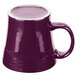 A white china mug with a purple exterior and silver rim and handle.