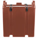 A brick red Cambro insulated soup carrier with a lid.