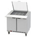 A Beverage-Air stainless steel refrigerated sandwich prep table with two drawers and clear lids.