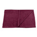 A folded burgundy Monarch Brands hand towel.