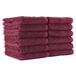 A stack of burgundy Monarch Brands hand towels.