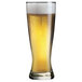 An Arcoroc Grand Pilsner glass filled with beer and foam.