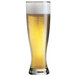 A customizable Arcoroc Grand Pilsner glass filled with beer and foam.