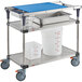 A Metro PrepMate Seafood Prep Multistation cart with white containers and a blue tray.