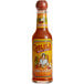 A close up of a Cholula Chili Garlic Hot Sauce bottle with a red label.