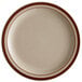 A close-up of a Libbey narrow rim stoneware plate with brown bands on a white surface.