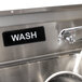 A black and white rectangular sign that says "Wash" by Thunder Group.